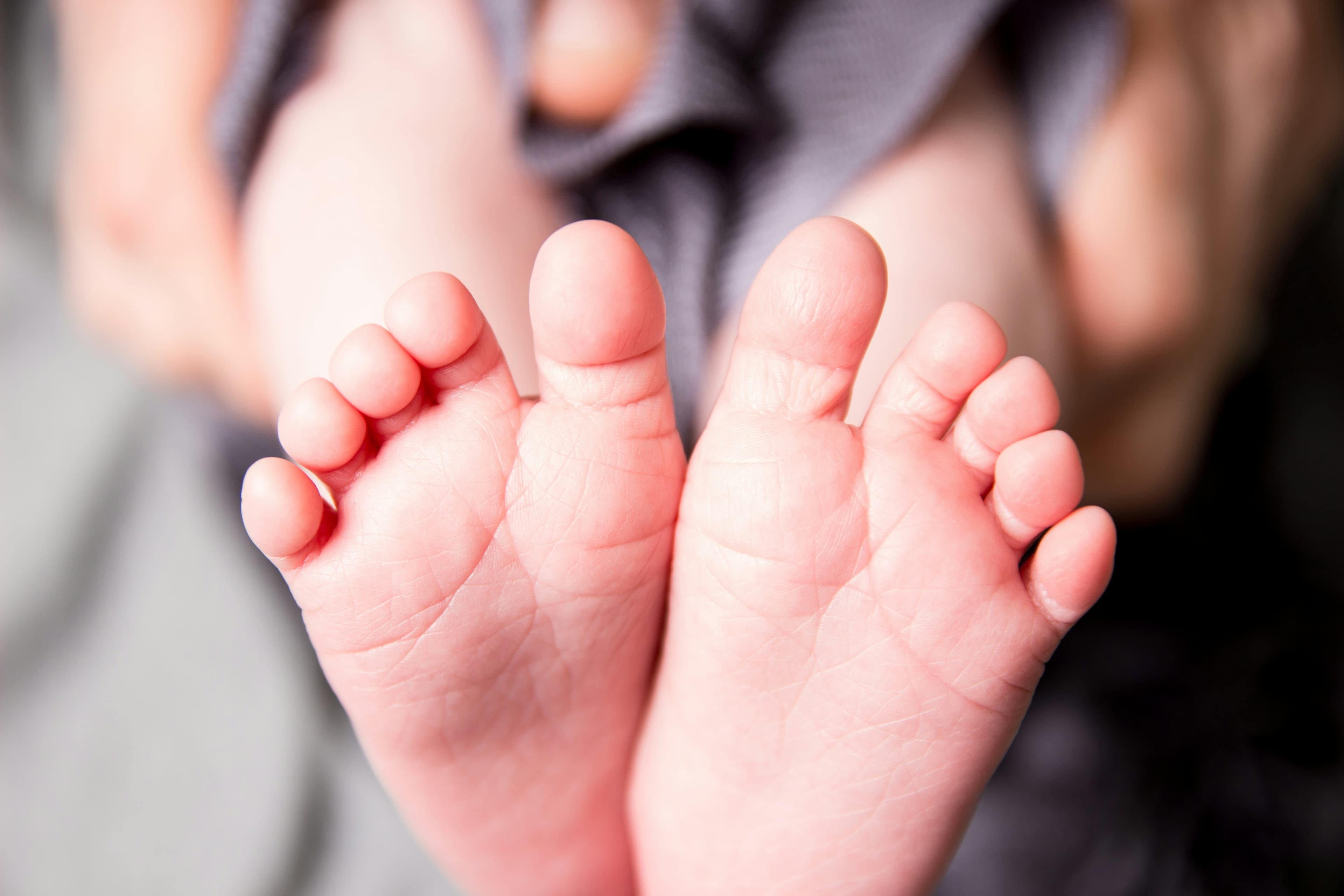 Family in bed with their newborn baby