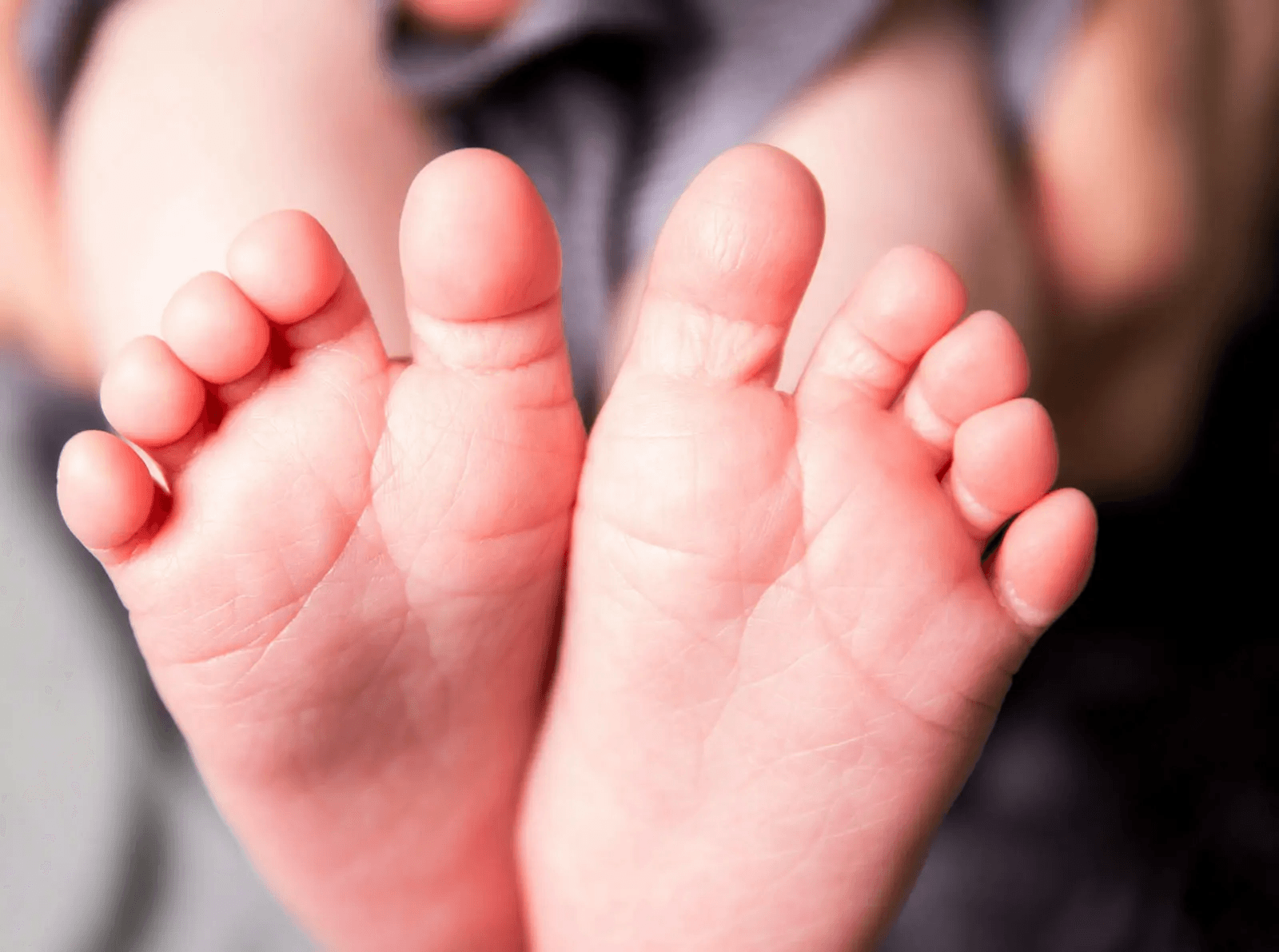 Family in bed with their newborn baby